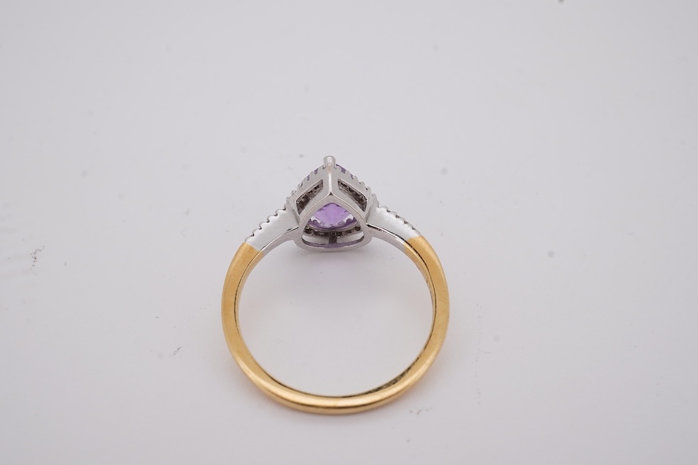 A modern 18ct gold and single stone pear cut amethyst set ring, with diamond chip set border and shoulders, size O, gross weight 3.4 grams. Condition - fair to good